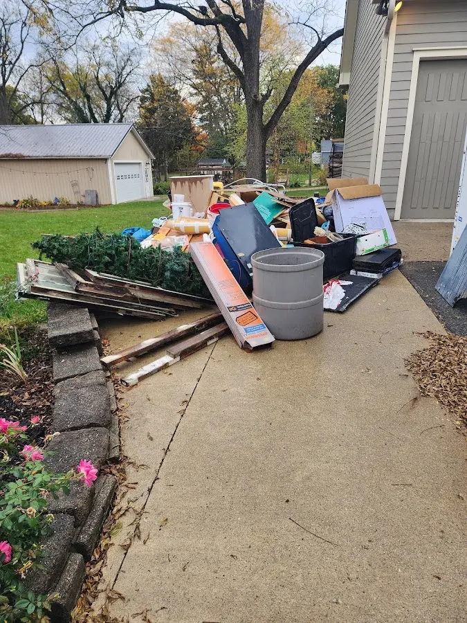 Dumpster being loaded with debris for Estate Cleanout Dumpster Rental in Springfield